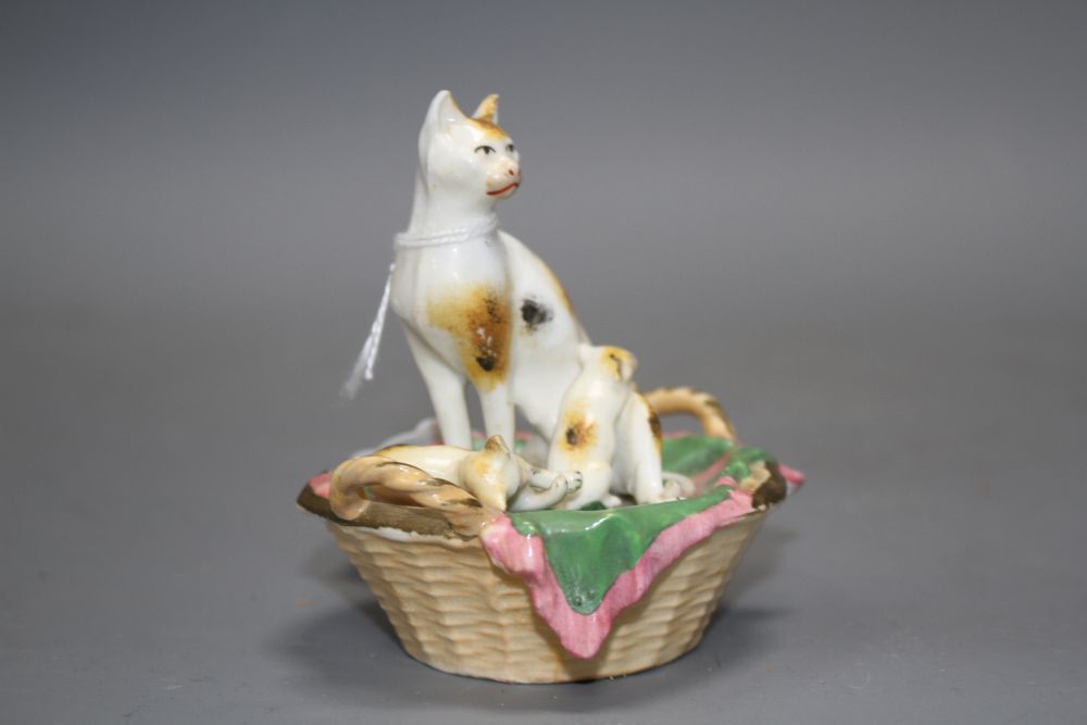 A Staffordshire porcelain group of a cat and two kittens in basket, c.1830-50, possibly Dudson,